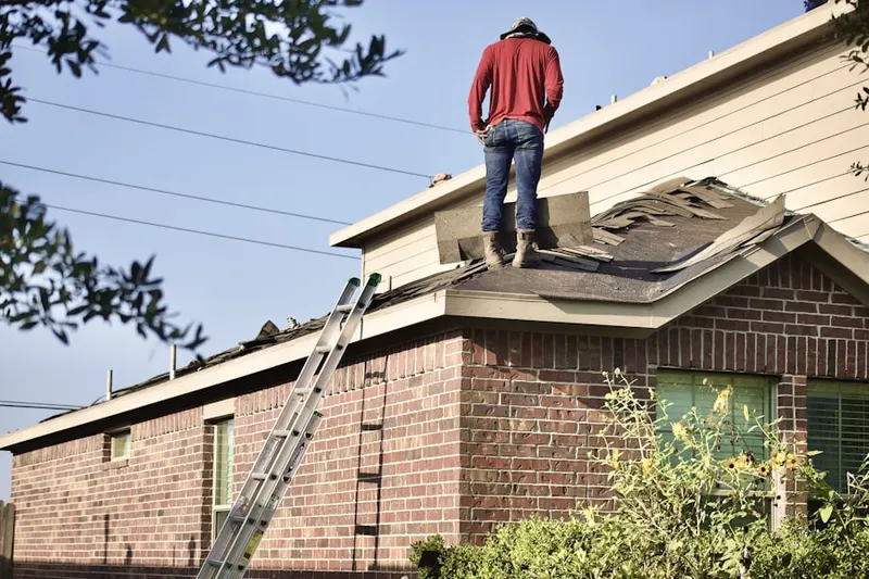 Professional roofer working on a residential roof in Crims Crossroads